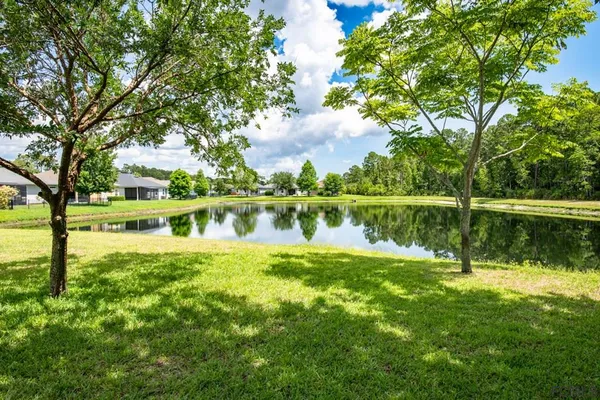 a view of a lake with houses in the back