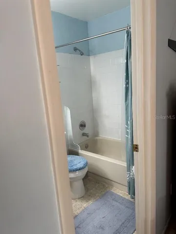 a bedroom with a bed dresser and a window