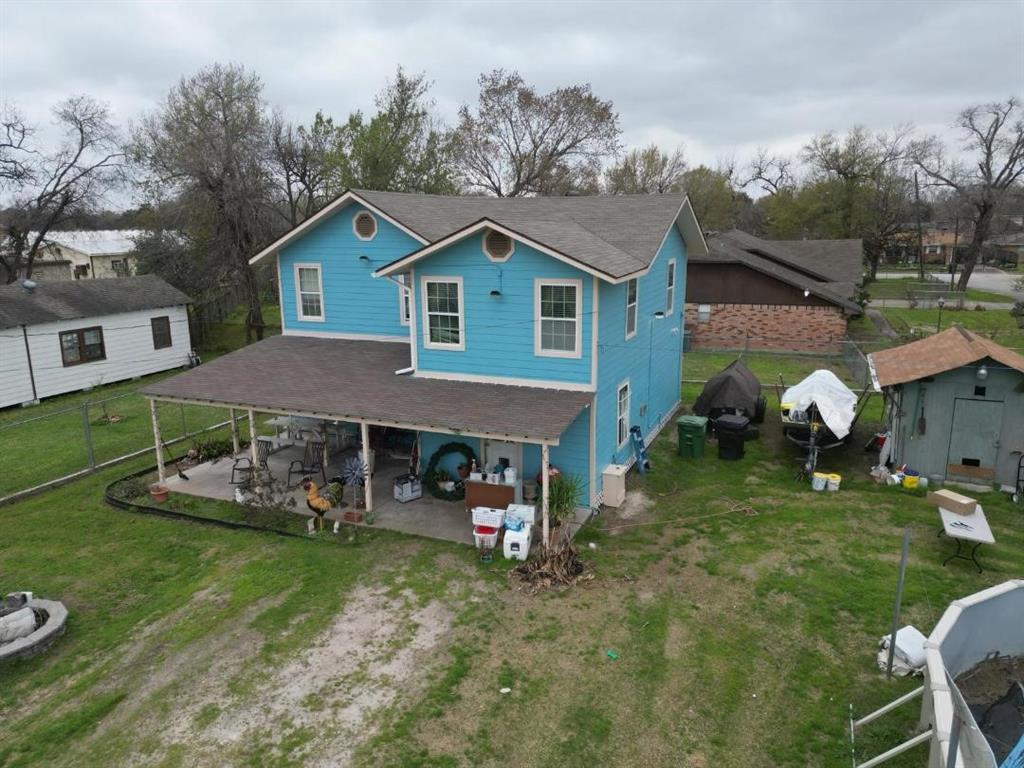 an aerial view of a house with a yard table and chairs