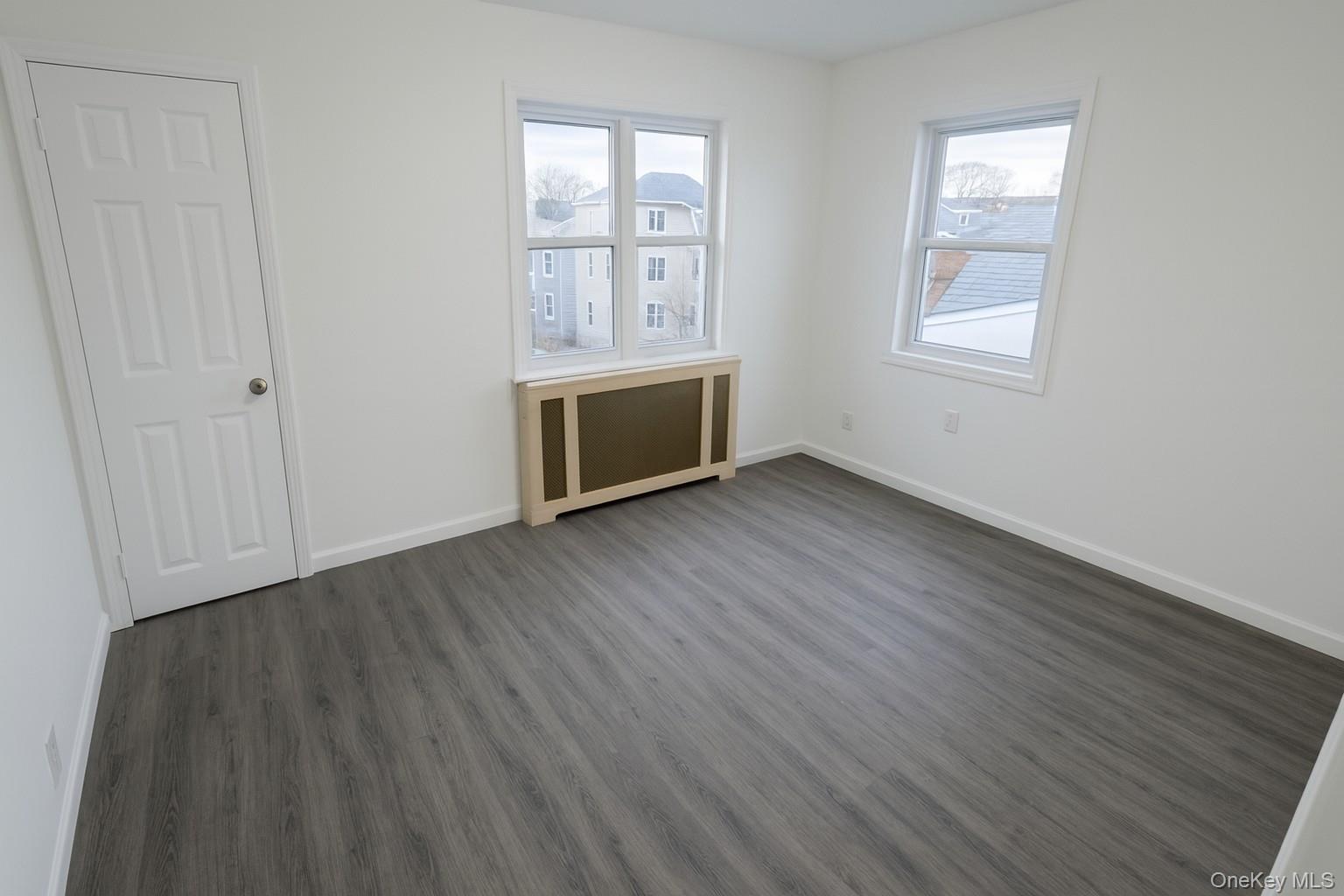 540 East State Street Long Beach, NY 11561 - Photo 10 of 12 Unfurnished bedroom featuring radiator heating unit and wood finished floors