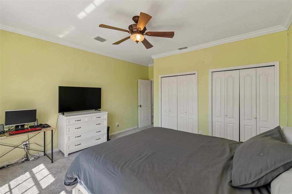 703 Bunker View Drive Apollo Beach, FL 33572 - Photo 25 of 49 a bedroom with a bed and a flat screen tv
