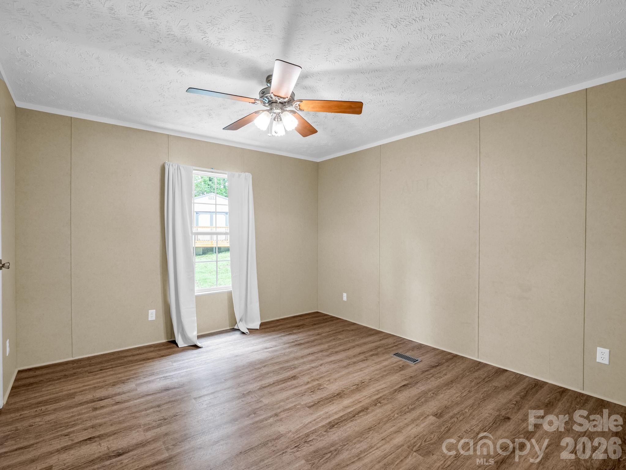 1449 Toney Road Bostic, NC 28018 - Photo 24 of 43 an empty room with wooden floor fan and windows