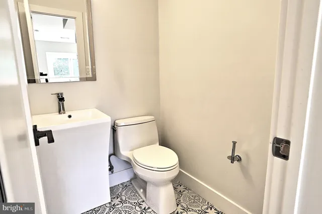 a white toilet sitting next to a bathroom sink