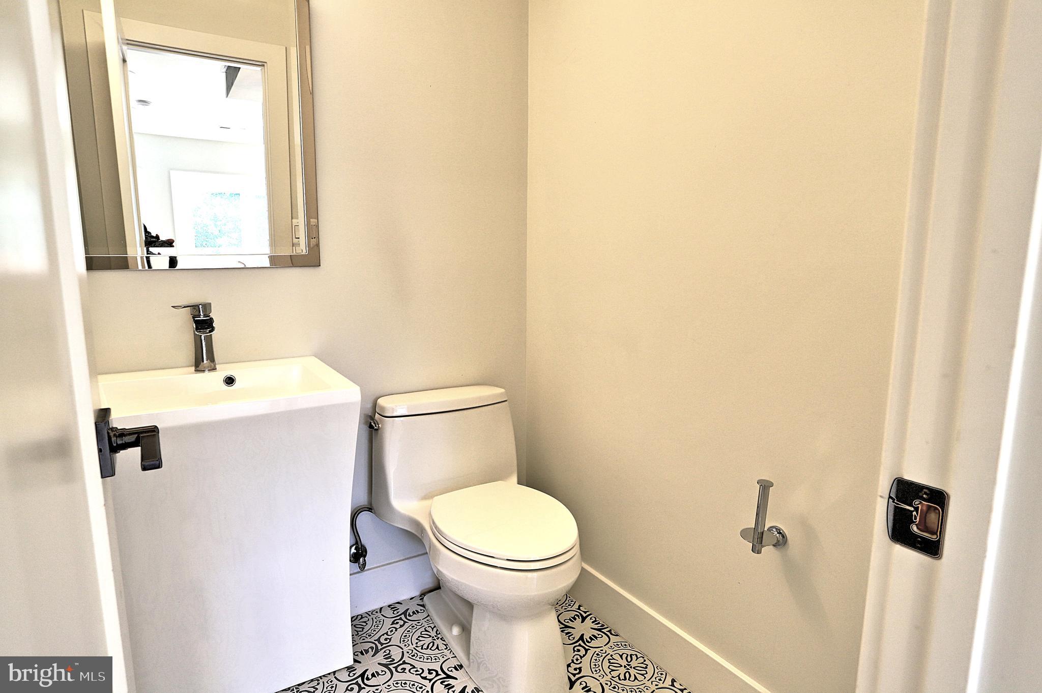 1723 Wisconsin Avenue Northwest, Unit B Washington, DC 20007 - Photo 12 of 20 a white toilet sitting next to a bathroom sink