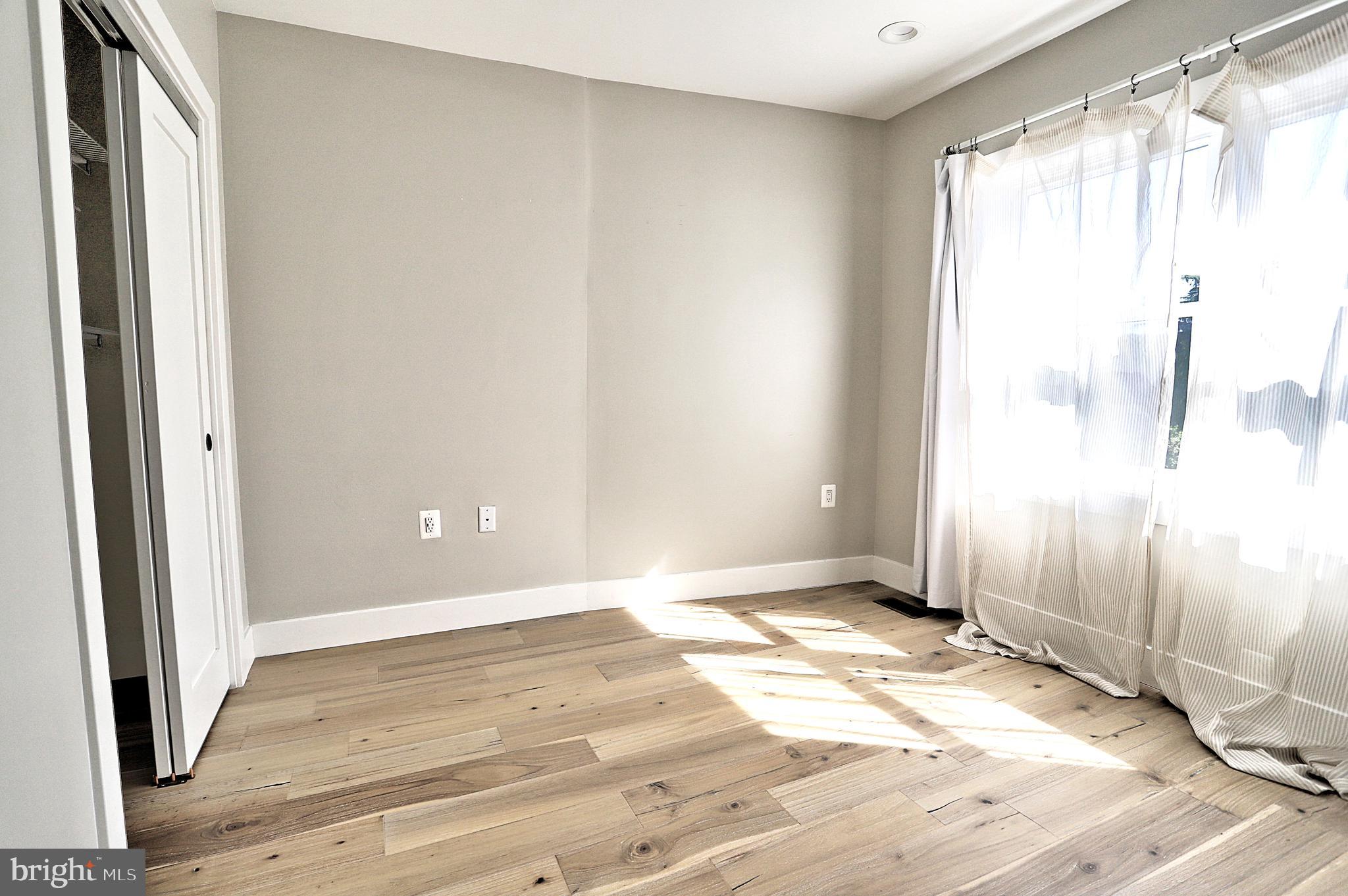 1723 Wisconsin Avenue Northwest, Unit B Washington, DC 20007 - Photo 16 of 20 a view of an empty room with wooden floor and a window