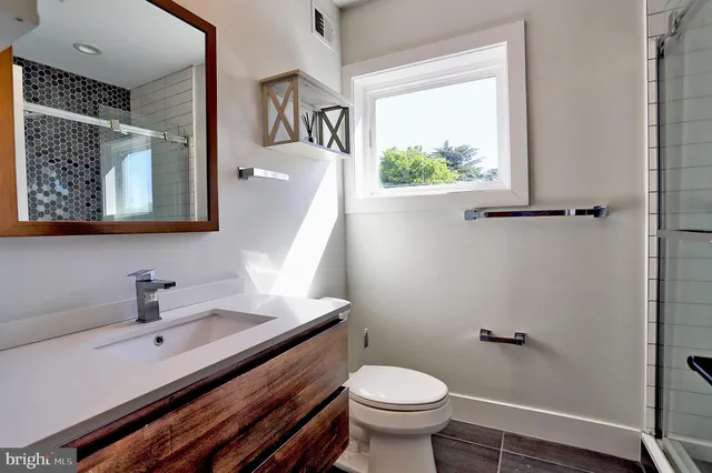 a bathroom with a sink a mirror and a toilet