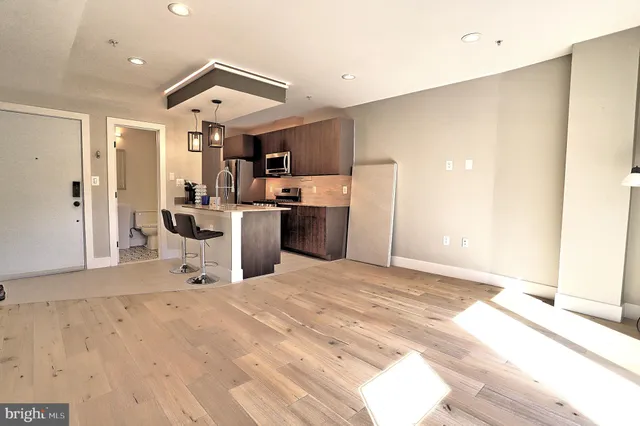 a view of a kitchen with a sink and cabinets