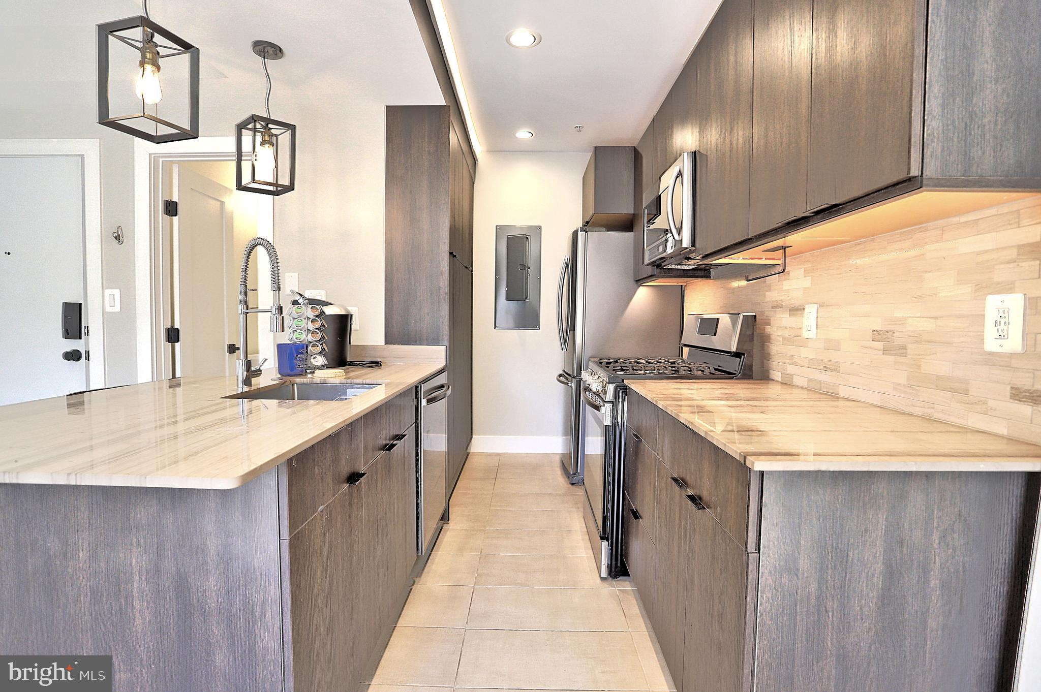 1723 Wisconsin Avenue Northwest, Unit B Washington, DC 20007 - Photo 5 of 20 a large bathroom with a granite countertop sink and a mirror