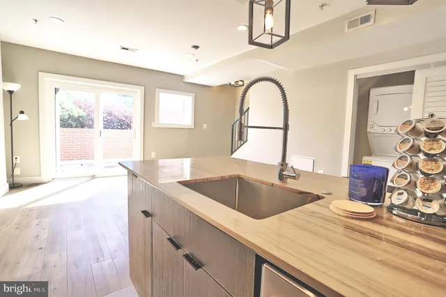a view of a kitchen with a sink and cabinets