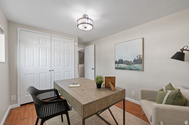 2370 Quail Run Circle East Sandy, UT 84093 - Photo 26 of 54 Neutral wall tones, wood-finish flooring, and a contemporary ceiling light fixture