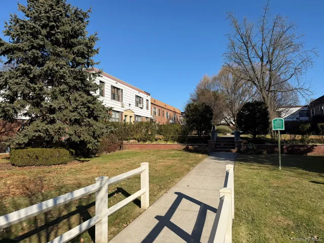 a view of an house with backyard and trees