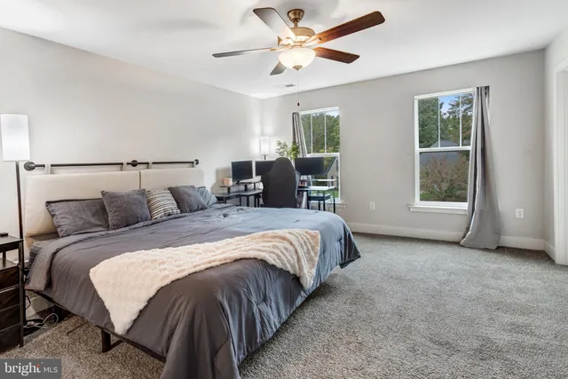 a bedroom with a bed and a large window