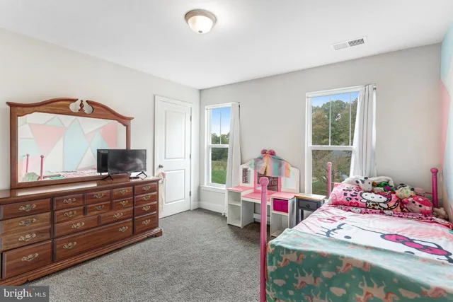 a living room with baby crib furniture and a window