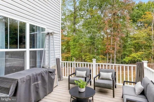 a view of a deck with furniture and a yard
