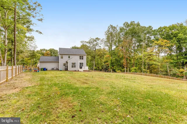 a house view with swimming pool in front of it