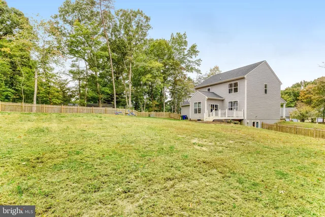 a house view with swimming pool in front of it