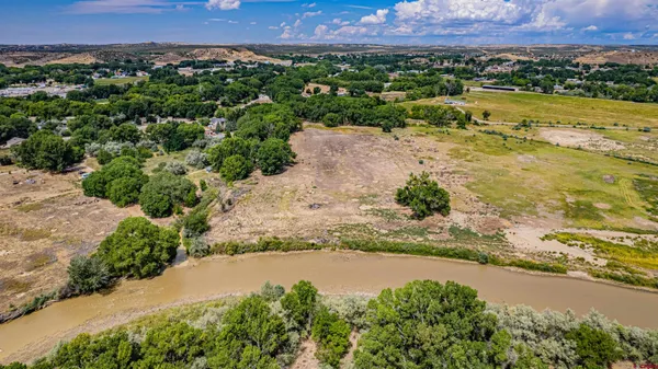 an aerial view of beach and residential houses with outdoor space and swimming pool