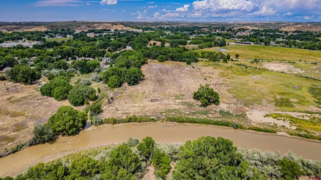 an aerial view of beach and residential houses with outdoor space and swimming pool