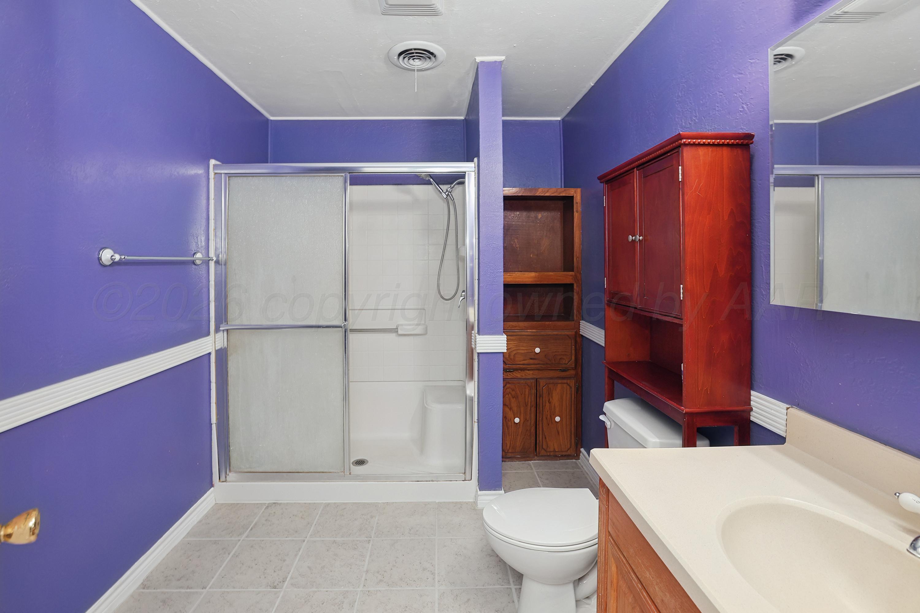 14200 Savannah Road Amarillo, TX 79118 - Photo 14 of 34 a bathroom with a sink a toilet and shower