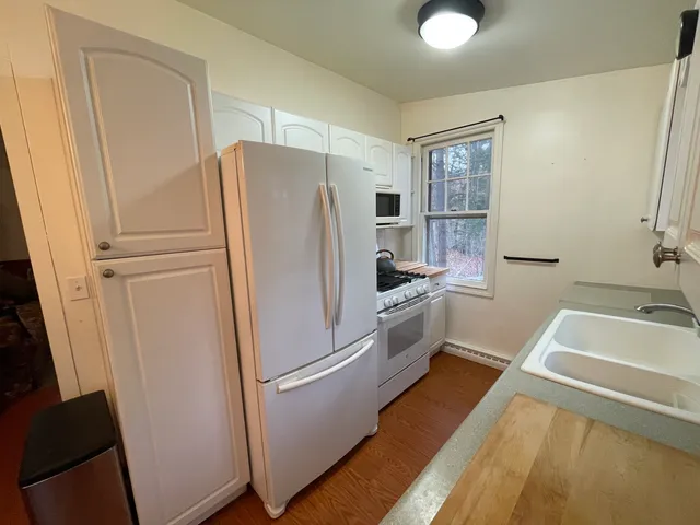 a white refrigerator freezer sitting inside of a kitchen