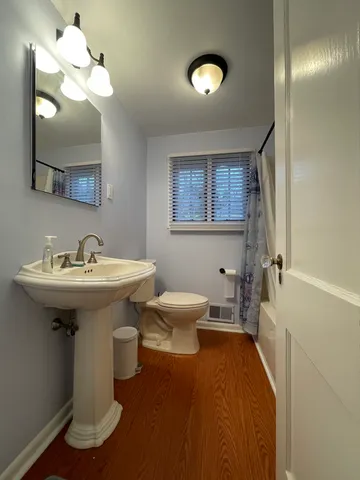 a bathroom with a sink a toilet and a mirror