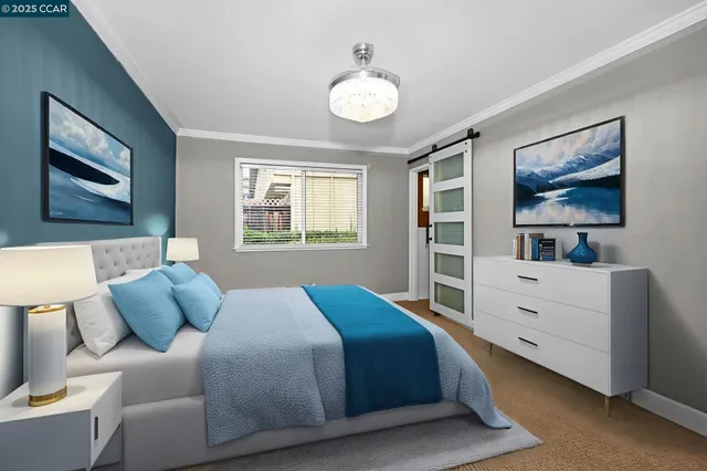 a bedroom with a large bed and a chandelier