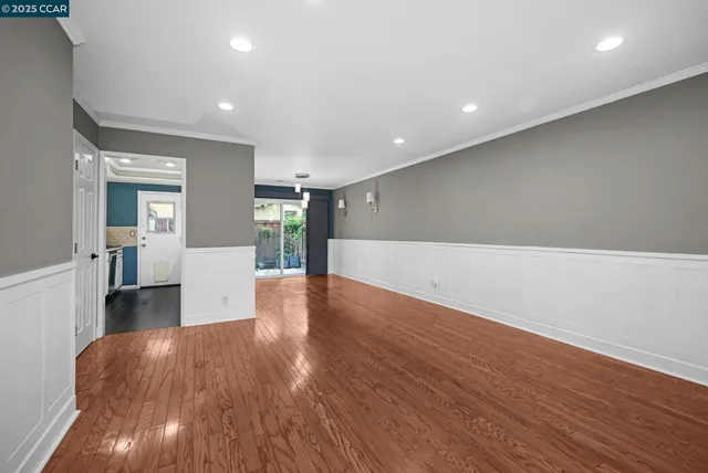 a view of a kitchen with wooden floor and a sink