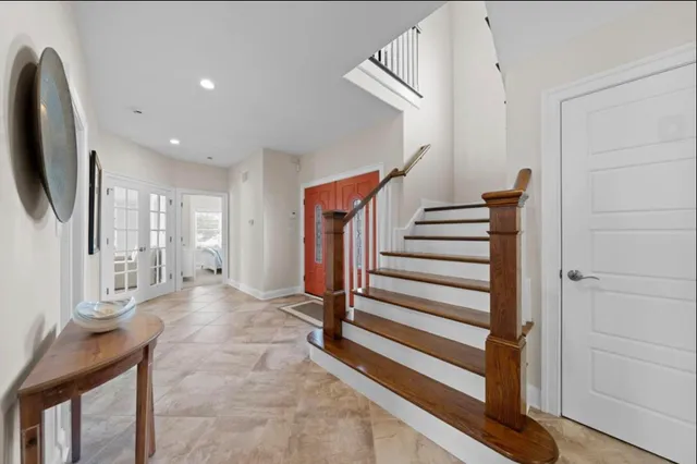 a view of a livingroom with wooden floor and stairs