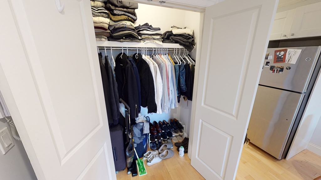 296 Beacon Street, Unit 2 Boston, MA 02116 - Photo 4 of 13 a view of walk in closet with clothes and shoes