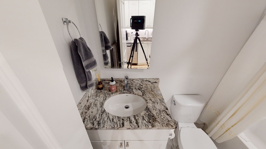 296 Beacon Street, Unit 2 Boston, MA 02116 - Photo 10 of 13 a bathroom with a sink and a mirror