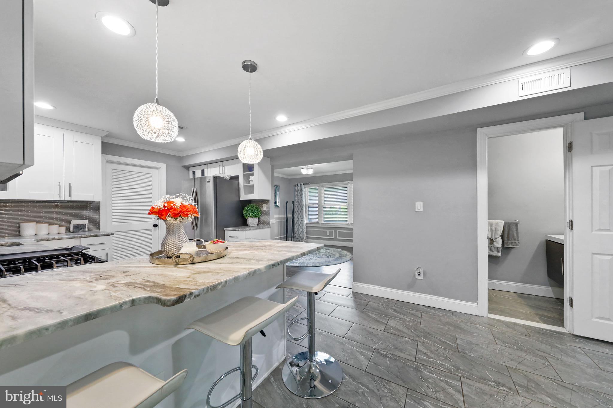 20 Pebble Lane Willingboro, NJ 08046 - Photo 11 of 38 a view of a dining room and kitchen island with wooden floor