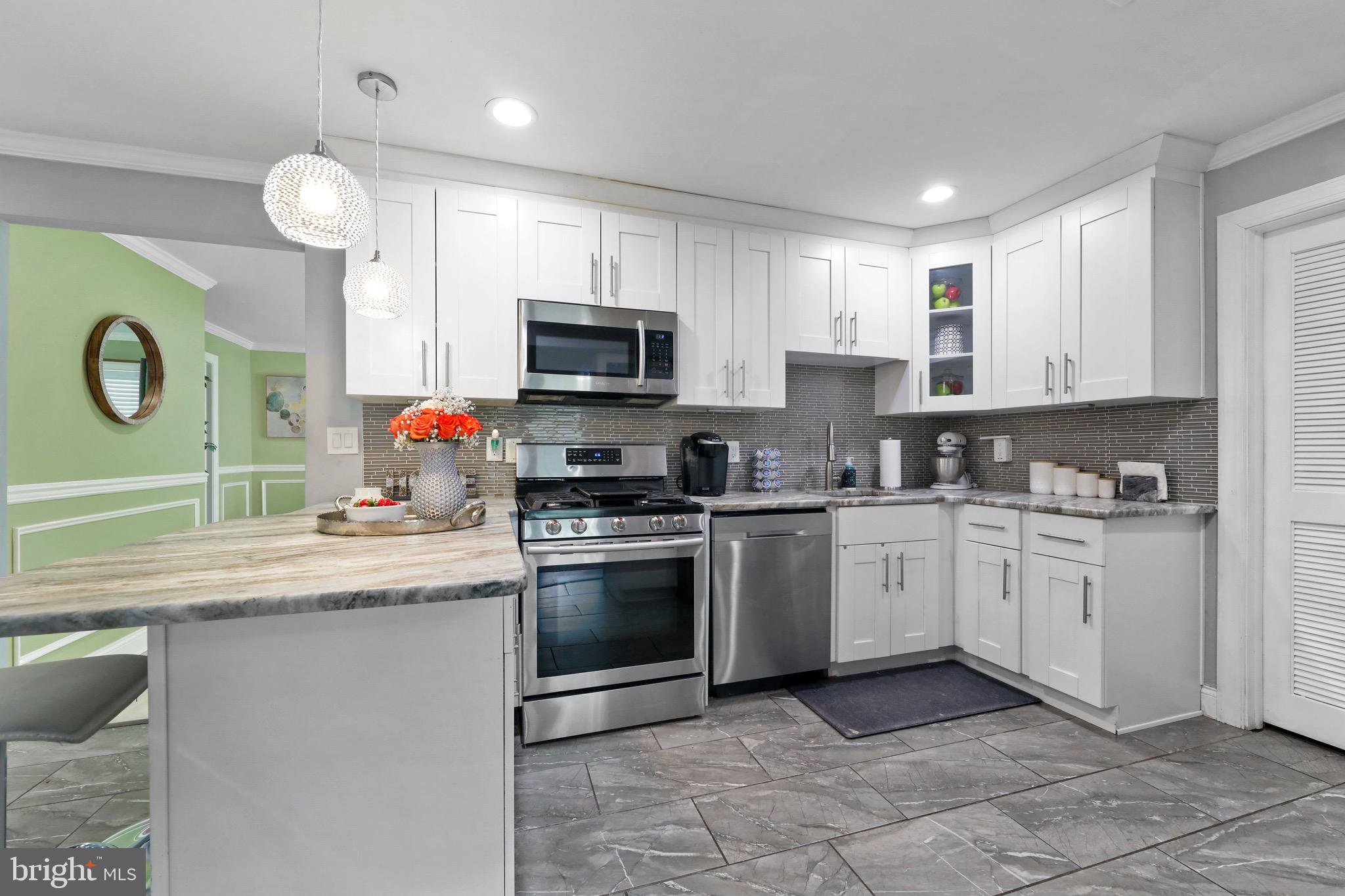 20 Pebble Lane Willingboro, NJ 08046 - Photo 12 of 38 a kitchen with granite countertop a sink stainless steel appliances and cabinets