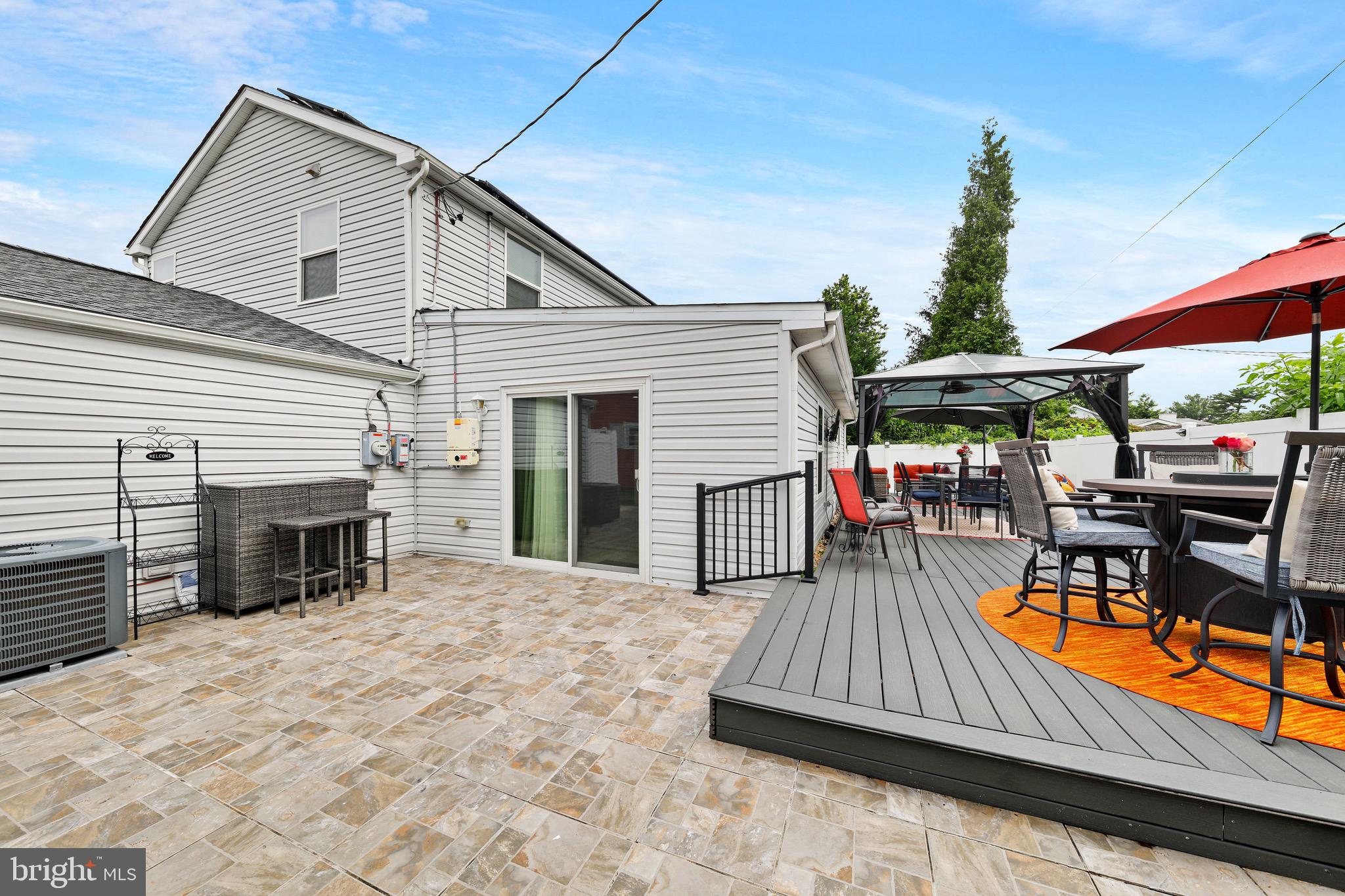 20 Pebble Lane Willingboro, NJ 08046 - Photo 38 of 38 a view of a roof deck with dining table and chairs with wooden floor