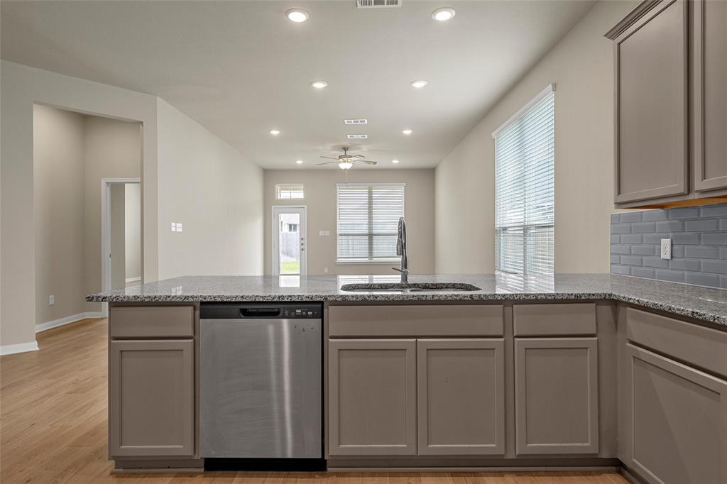 3205 Dottavio Road Lorena, TX 76655 - Photo 12 of 33 a kitchen with granite countertop cabinets and window