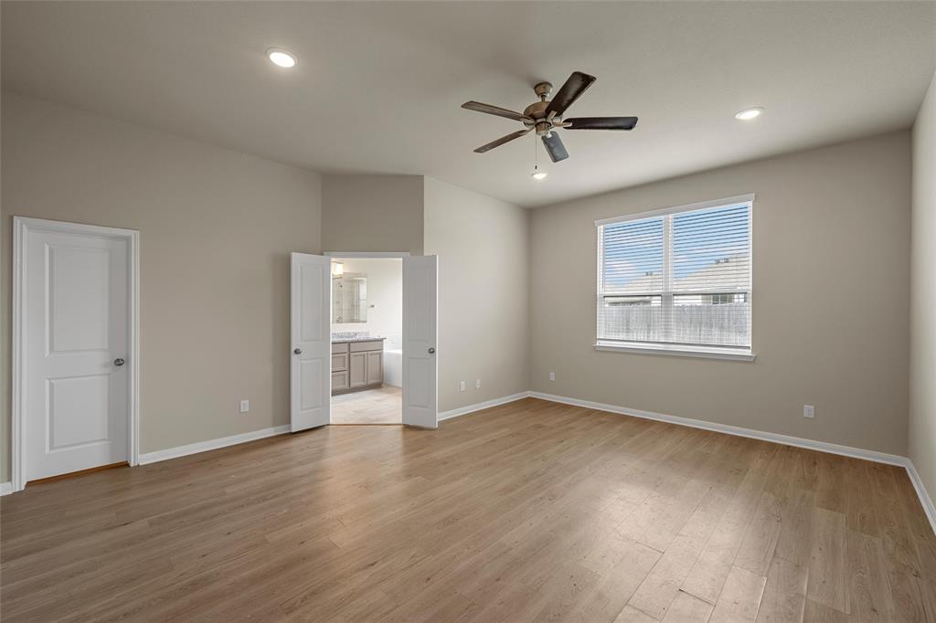 3205 Dottavio Road Lorena, TX 76655 - Photo 14 of 33 a view of an empty room with wooden floor and a window