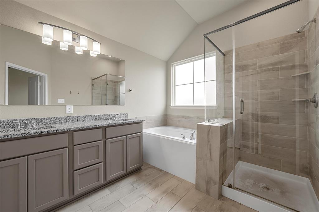 3205 Dottavio Road Lorena, TX 76655 - Photo 17 of 33 a bathroom with a granite countertop sink a mirror a bathtub and next to a window