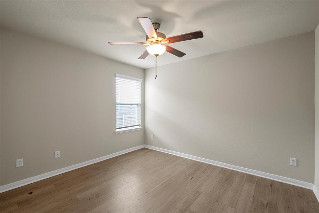 3205 Dottavio Road Lorena, TX 76655 - Photo 20 of 33 a view of a room with window ceiling fan and wooden floor