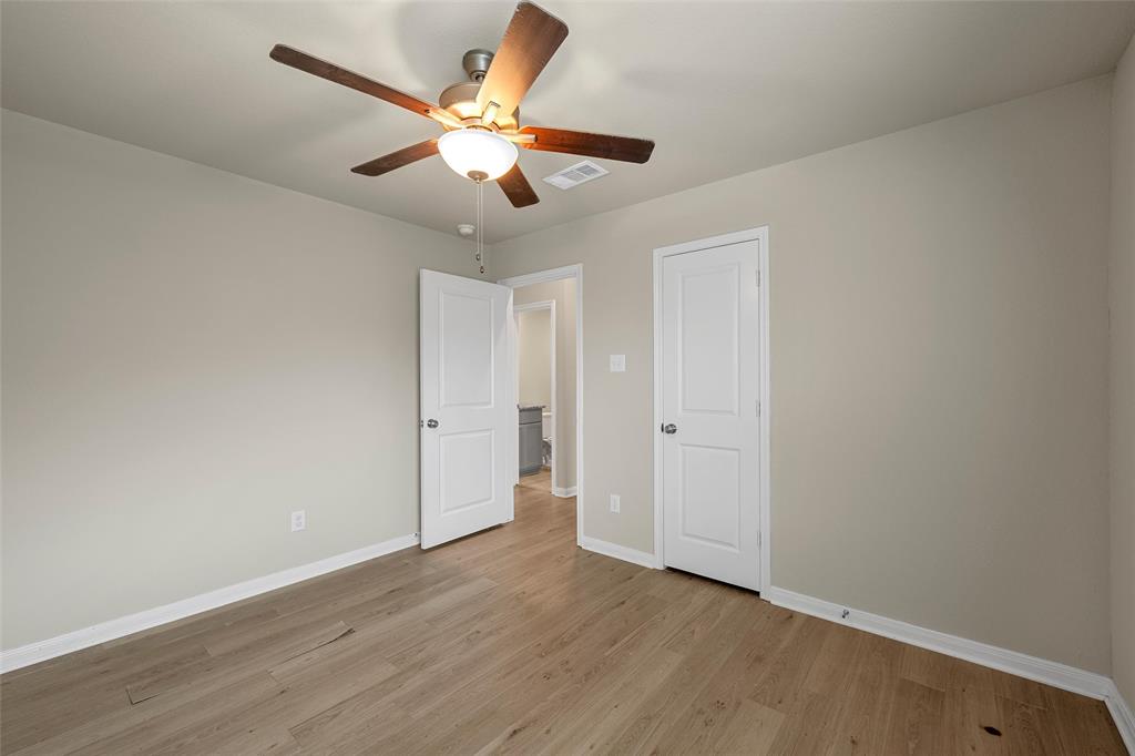 3205 Dottavio Road Lorena, TX 76655 - Photo 21 of 33 an empty room with wooden floor and ceiling fan