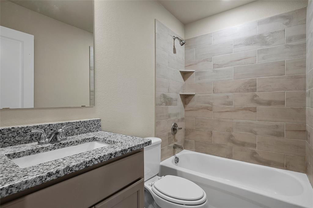 3205 Dottavio Road Lorena, TX 76655 - Photo 22 of 33 a bathroom with a granite countertop bathtub shower sink vanity and toilet