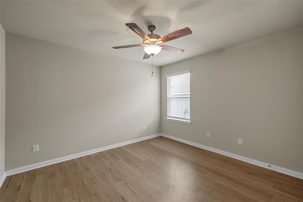 3205 Dottavio Road Lorena, TX 76655 - Photo 23 of 33 a view of a livingroom with a ceiling fan and wooden floor