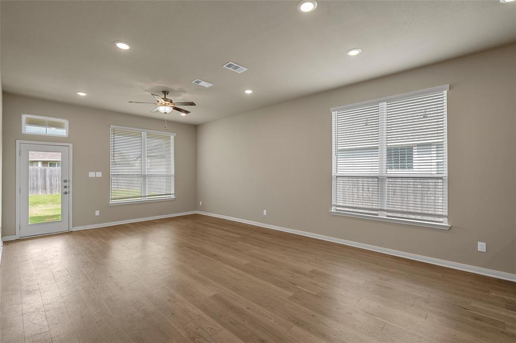 3205 Dottavio Road Lorena, TX 76655 - Photo 4 of 33 a view of an empty room with wooden floor and a window