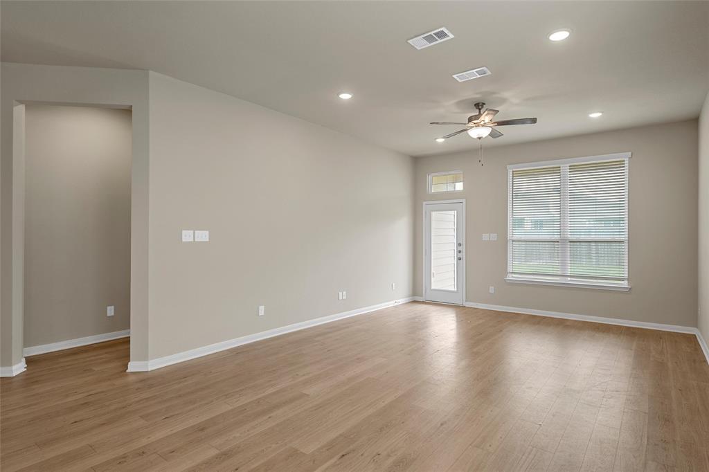 3205 Dottavio Road Lorena, TX 76655 - Photo 5 of 33 a view of an empty room with a window and wooden floor