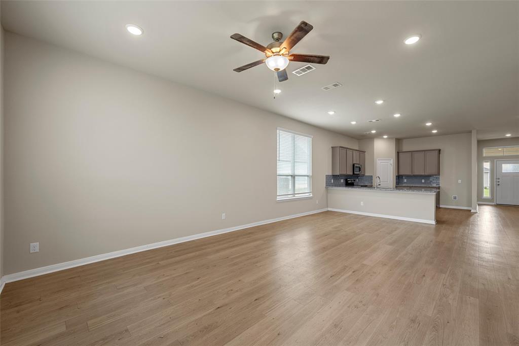 3205 Dottavio Road Lorena, TX 76655 - Photo 6 of 33 an empty room with wooden floor and windows