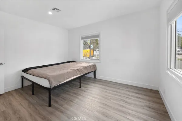 a bedroom with bed and window