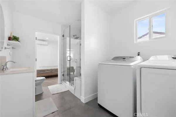 a bathroom with a granite countertop toilet sink and mirror
