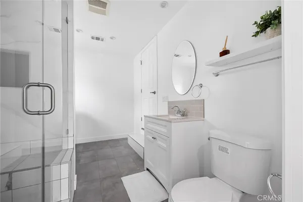 a room with a bed and wooden floor