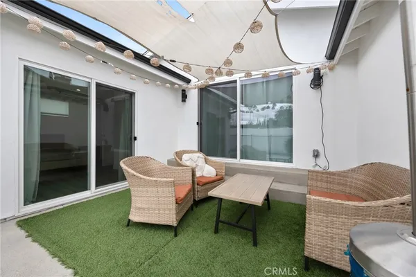 a front view of a house with a garden and plants