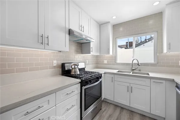 a kitchen with sink cabinets and appliances