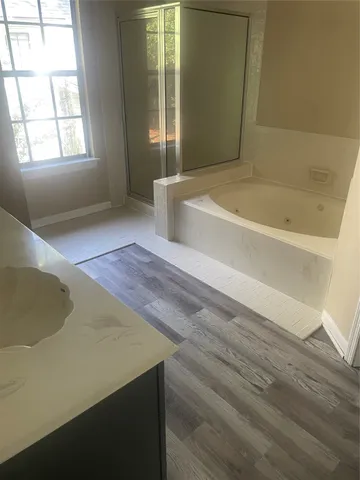 a bathroom with a bathtub and window