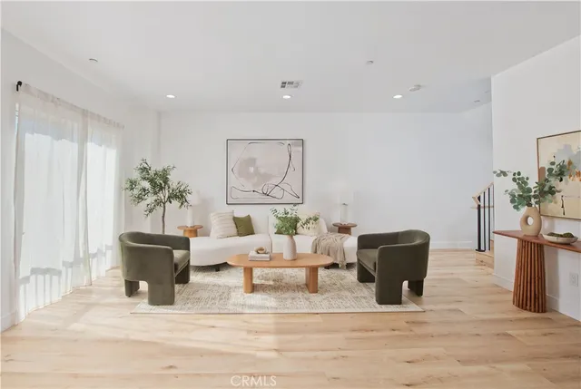 a living room with furniture and a potted plant